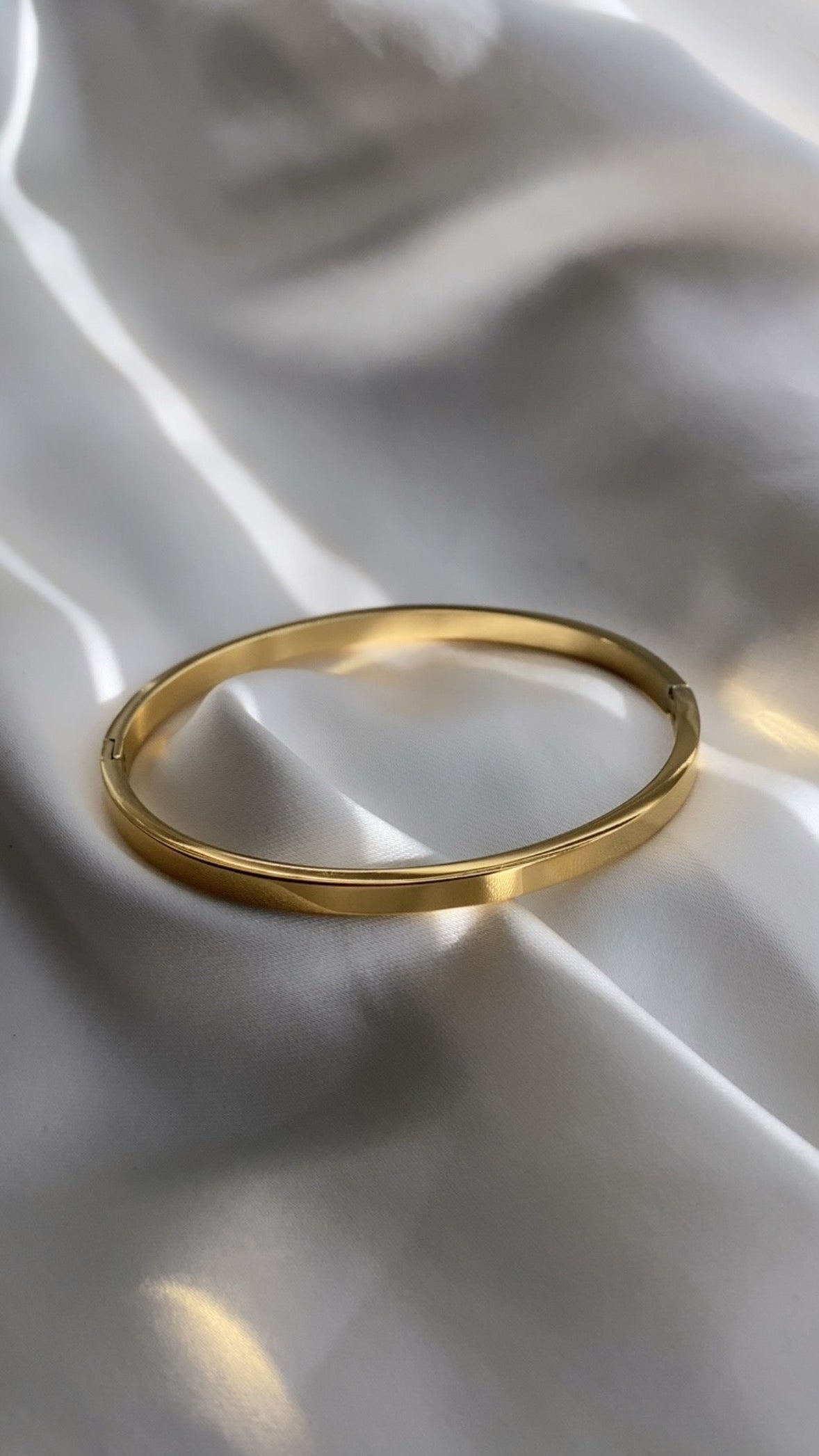 Gold ring on a white fabric background