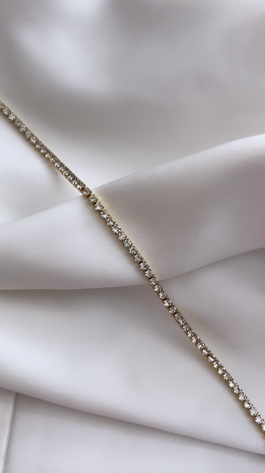 Silver bracelet on a light fabric background