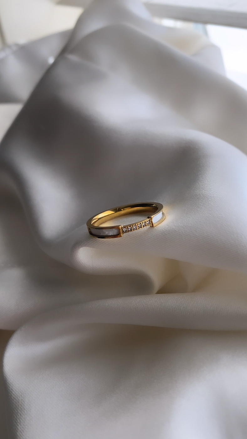 Gold ring on a white fabric background