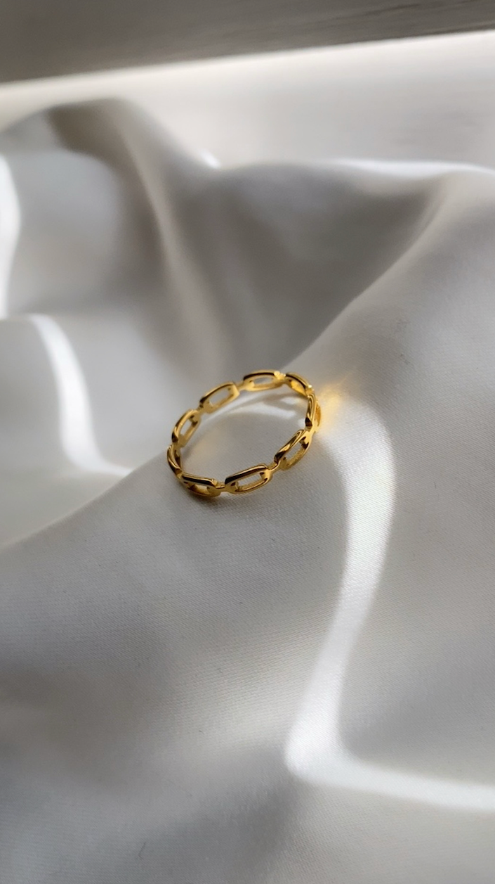 Gold ring on a white fabric surface